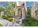 A vibrant red door and wrought iron details welcomes you to this well-maintained two-story home with lovely curb appeal at 5350 Penway Dr, Orlando, FL 32814