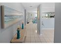 Inviting hallway with neutral tones and tile flooring leads to the dining room and kitchen at 543 Silver Crse, Ocala, FL 34472
