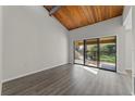 Bright living room with vaulted wood ceilings and sliding glass doors to the balcony at 6120 Peregrine Ave # A08-2, Orlando, FL 32819