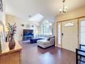 Spacious living room featuring hardwood floors, a vaulted ceiling, and a large window that brings in ample natural light at 700 Wyckliffe Pl, Winter Springs, FL 32708