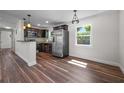 Modern kitchen with stainless steel appliances, dark cabinetry, and a breakfast bar at 709 Suzette Dr, Ocoee, FL 34761