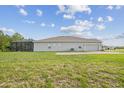 The backyard has a screened-in patio and green space at 730 Rominger Loop, Apopka, FL 32712