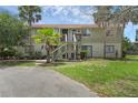 Two-story townhouse with exterior stairs and an asphalt driveway at 7344 Swallow Run # 7344, Winter Park, FL 32792