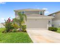 Charming two-story home with a two-car garage and a well-maintained front yard at 7603 Taormina Way, Clermont, FL 34714