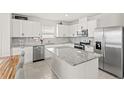Modern kitchen with stainless steel appliances, granite countertops, and ample cabinet space at 7603 Taormina Way, Clermont, FL 34714