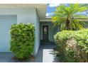 View of the Front Entrance featuring a well-maintained walkway and mature landscaping at 945 Shawna Shrs, Haines City, FL 33844