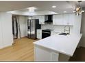 Modern kitchen featuring white cabinets, stainless steel appliances, and quartz countertops at 1055 Kensington Park Dr # 205, Altamonte Springs, FL 32714