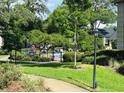 Community pool area surrounded by lush landscaping and a secure fence at 1055 Kensington Park Dr # 205, Altamonte Springs, FL 32714