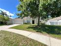 Beautiful single-story home with an attached garage, a manicured lawn, and mature shade trees at 109 Belgian Way, Sanford, FL 32773