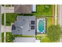 Aerial view of a home with a screened-in pool and solar panels on the roof at 1224 Blackwater Pond Dr, Orlando, FL 32828