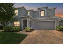 Charming two-story home featuring a spacious driveway during a lovely dusk at 1292 Cavender Creek Rd, Minneola, FL 34715