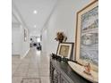 Inviting hallway with tiled flooring, decorative console table, and art displays at 145 Piave St, Haines City, FL 33844