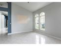 Spacious living area with tile flooring and a view of arched windows for ample natural light at 1456 Sun Meadow Dr, Orlando, FL 32824