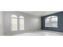 Bright living room featuring neutral walls, tile flooring, and arched windows for natural light at 1456 Sun Meadow Dr, Orlando, FL 32824
