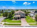 Stunning two story home with a two car garage, brick driveway, and luscious green lawn at 15900 Citrus Knoll Dr, Winter Garden, FL 34787