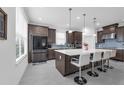 Gourmet kitchen features an island with seating, stainless steel appliances, and sleek modern cabinetry at 1593 Osprey View Dr, Apopka, FL 32703
