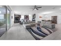 Spacious living room with tile flooring, modern furniture, and sliding glass doors leading to an outdoor area at 1593 Osprey View Dr, Apopka, FL 32703