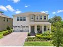 Charming two-story home with a brick driveway and a welcoming front porch at 17996 Adrift Rd, Winter Garden, FL 34787