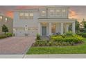 Inviting two-story home with a spacious front porch and three-car garage at 17996 Adrift Rd, Winter Garden, FL 34787