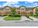 Attractive townhomes feature attached garages, neutral exteriors, landscaping and individual driveways at 2508 Seven Oaks Dr, St Cloud, FL 34772