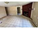 Vacant living room with tile floors and a fireplace provides a blank canvas for a new owner's vision at 2601 Tennessee Rd, Lakeland, FL 33815