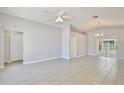 Spacious living room featuring neutral paint, tile flooring, ceiling fan, and sliding glass doors at 2742 Woodruff Dr, Orlando, FL 32837