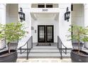 Inviting main entrance of building 300 with black double doors and manicured plants at 300 E South St # 6016, Orlando, FL 32801