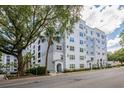 Exterior view of building with multiple windows and palm trees surrounding at 300 E South St # 6016, Orlando, FL 32801