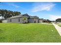 Well-maintained single-story home featuring a spacious green lawn and a side view of the property at 3101 Linton Rd, Kissimmee, FL 34758