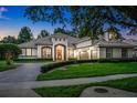 Striking exterior view of a grand home, beautifully landscaped with lush greenery and mature trees at 3316 Regal Crest Dr, Longwood, FL 32779