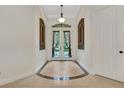 Elegant foyer featuring decorative double doors, tile flooring, and arched transom windows at 3316 Regal Crest Dr, Longwood, FL 32779