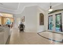 Inviting foyer boasts tile floors, decorative doorway and open access to the living and dining areas at 3316 Regal Crest Dr, Longwood, FL 32779