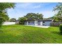 Spacious backyard featuring a well-maintained lawn with a patio area and privacy fencing at 4006 Kasper Dr, Orlando, FL 32806