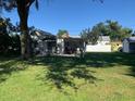 Backyard featuring a well-maintained lawn, a covered patio, and a serene outdoor space at 421 Ohio Ave, St Cloud, FL 34769