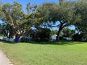 Quaint home shaded by mature trees, with a spacious lawn and an exterior view at 421 Ohio Ave, St Cloud, FL 34769