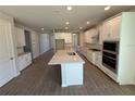 Spacious kitchen with a large center island, sleek white cabinets, and stainless appliances at 441 Lady Palm St, Apopka, FL 32703