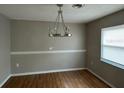 Dining room with wooden floor and modern chandelier lighting at 4732 Luce Rd, Lakeland, FL 33813