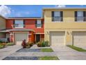 Inviting townhome featuring colorful exteriors, attached garages, and well maintained landscaping at 509 Cresting Oak Cir # 73, Orlando, FL 32824