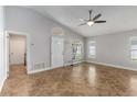 Bright living room boasts high ceilings, tile flooring, and ample natural light from multiple windows at 5703 Arnold Zlotoff Dr, Orlando, FL 32821