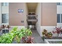 Close up of condo building with mature green landscaping surrounding the entryway at 614 Orange Dr # 196, Altamonte Springs, FL 32701