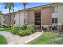 Well-maintained condo building with lush green lawns and mature palm trees at 614 Orange Dr # 196, Altamonte Springs, FL 32701