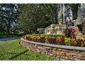 Stonebridge Place community sign with lush landscaping, colorful foliage, and manicured greenery at 6214 Stevenson Dr # 208, Orlando, FL 32835