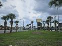 Sign view of the real estate, with street and palm trees in the background at 7900 S Orange Blossom Trl, Orlando, FL 32809