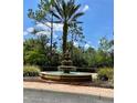 A beautiful tiered water fountain sits as a focal point amongst the lush tropical landscaping of the property at 8010 Tuscany Way # 3102, Davenport, FL 33896