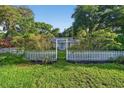 Charming single-story home with a bright blue front door and picket fence at 815 E 11Th Ave, Mount Dora, FL 32757