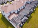Townhome aerial view showcases backyard pools and modern screened in patios for privacy at 8934 Stinger Dr, Davenport, FL 33896
