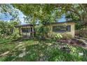 Single story home with lush greenery and mature landscaping at 905 Flewelling Ave, Ocoee, FL 34761