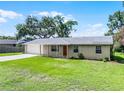 Charming single-story home features a well-maintained lawn, brick facade, and attached garage at 1011 W 13Th St, Lakeland, FL 33805