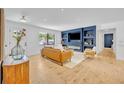 Stylish living room with built-in shelving, a modern fireplace, and a comfortable seating area at 107 Hilltop Dr, Longwood, FL 32750