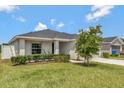Well-maintained lawn and manicured shrubs surround this beautiful home at 1159 Mountain Flower Ln, Davenport, FL 33837